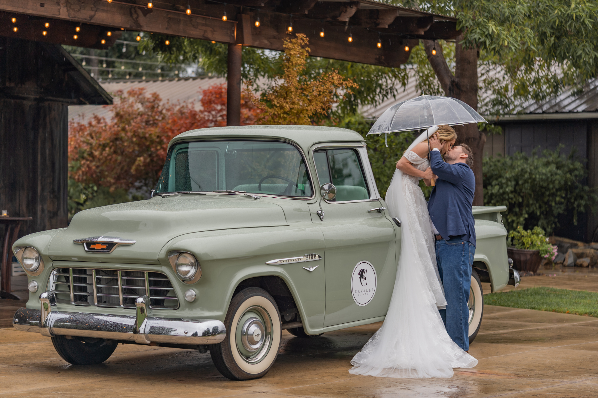 Bride and groom sharing an intimate rainy moment at Cavalli Estate in San Luis Obispo, photographed by Fonseca Hansen Media.
